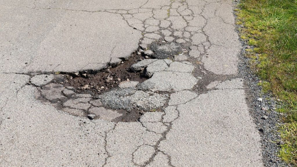 alligator cracks causing a pothole that needs crack filling on new jersey asphalt pavement
