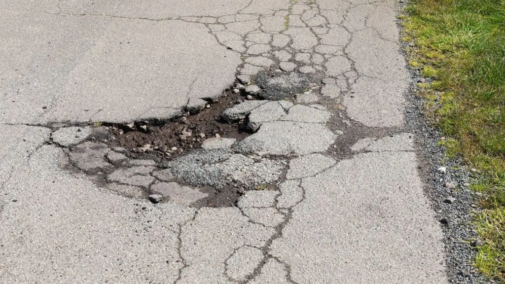 alligator cracks causing a pothole that needs crack filling on new jersey asphalt pavement