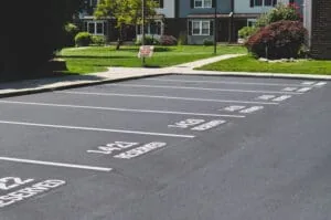 Resurfaced apartment parking lot with fresh white striping and numbered resident spaces