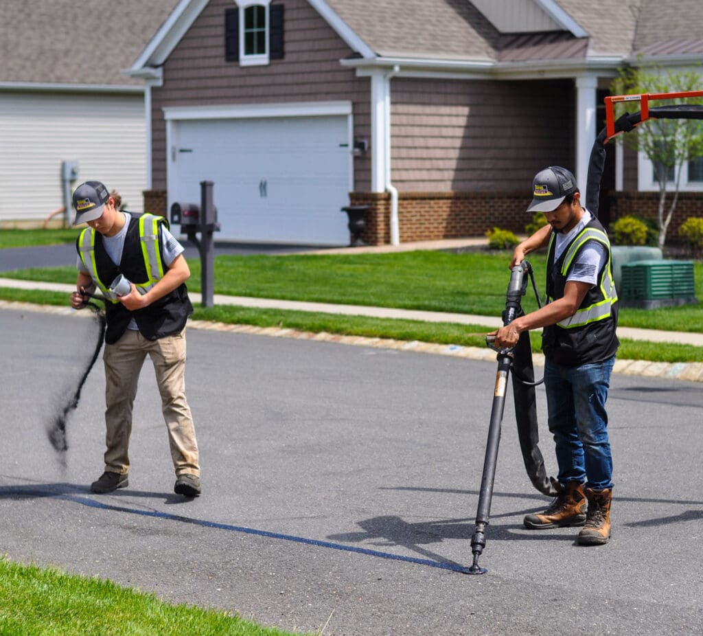crack filling and crack sealing project in progress on a roadway