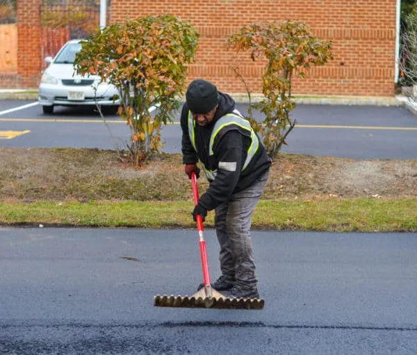 Eosso Brothers Paving Employee preforming an asphalt paving service