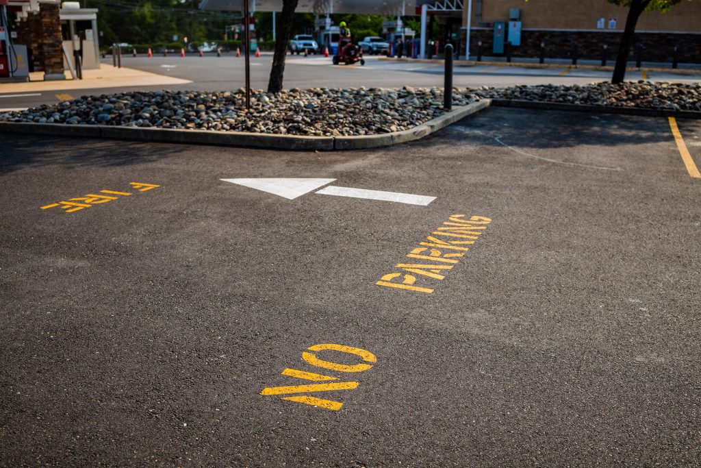 No parking with white arrow on lot